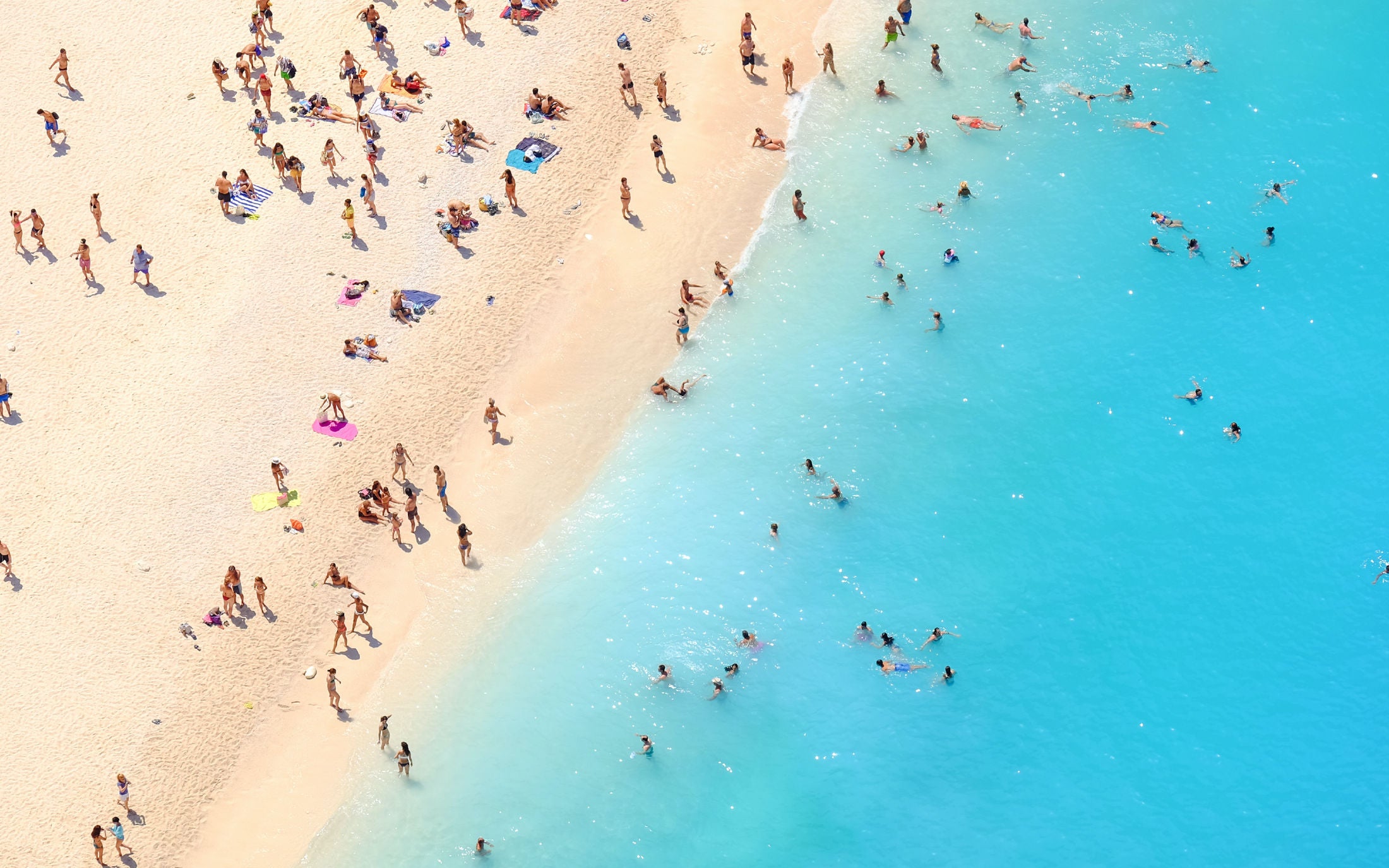 Aerial shot of tourists on a tropical beach