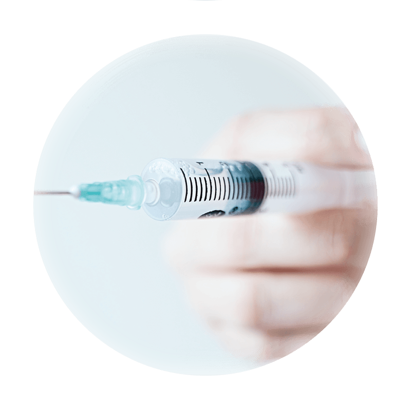 A close up of a hand holding a syringe